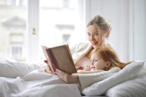 A parent who uses a speech therapy, Los Angeles based practice, reads to their child