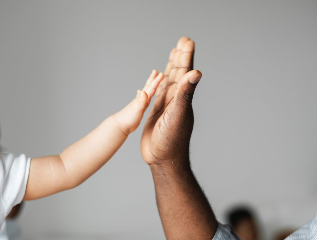An adult and child high five. Get help for your child with the best speech therapy Beverly Hills offers. 